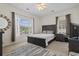 Well-lit bedroom featuring a large window, neutral walls, carpet and a dark wood bed at 2090 Cross Gate Blvd. # 205, Surfside Beach, SC 29575