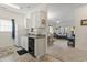 Cozy kitchen with white cabinets and appliances, open to the living room, creating a welcoming atmosphere at 2090 Cross Gate Blvd. # 205, Surfside Beach, SC 29575
