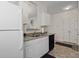 Functional kitchen with white cabinets and appliances, and a convenient view to the dining area at 2090 Cross Gate Blvd. # 205, Surfside Beach, SC 29575