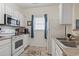 Bright kitchen featuring white cabinets and a window, creating a light and airy space for cooking at 2090 Cross Gate Blvd. # 205, Surfside Beach, SC 29575