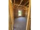 The interior of a house under construction with exposed wooden frames and a concrete floor at 2186 Mineral Springs Rd., Conway, SC 29527