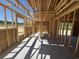 The interior of a house under construction with exposed wooden frames and a concrete floor at 2186 Mineral Springs Rd., Conway, SC 29527