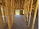 The interior of a house under construction with exposed wooden frames and a concrete floor at 2186 Mineral Springs Rd., Conway, SC 29527