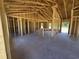 The interior of a house under construction with exposed wooden frames and a concrete floor at 2186 Mineral Springs Rd., Conway, SC 29527