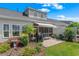 Lush backyard featuring a patio, grill, white awning and vibrant landscaping, bordering a serene waterway at 232 Je Edward Dr. # 21, Myrtle Beach, SC 29588