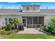 Well-maintained backyard with a patio, grill, screened in porch and lush landscaping, backing up to a waterway at 232 Je Edward Dr. # 21, Myrtle Beach, SC 29588