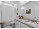 Well-lit bathroom featuring a granite countertop, white cabinets, and a shower with a white curtain at 2464 Rock Dove Rd., Myrtle Beach, SC 29577
