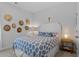 Bright bedroom featuring a white geometric headboard, blue patterned bedding, and unique hat decor at 2464 Rock Dove Rd., Myrtle Beach, SC 29577