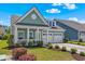 Home with a covered porch, a well-maintained yard, and an attached two-car garage on a sunny day at 2464 Rock Dove Rd., Myrtle Beach, SC 29577