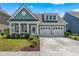 Charming single-Gathering home features a covered front porch, two-car garage, and manicured landscaping at 2464 Rock Dove Rd., Myrtle Beach, SC 29577