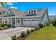 A charming house with a covered front porch, a driveway leading to a two-car garage, and a manicured lawn at 2464 Rock Dove Rd., Myrtle Beach, SC 29577