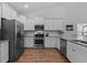 Modern kitchen featuring stainless steel appliances, granite countertops, and white cabinets at 2464 Rock Dove Rd., Myrtle Beach, SC 29577