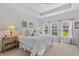 Serene main bedroom with large windows, plush bedding, and a ceiling fan at 2464 Rock Dove Rd., Myrtle Beach, SC 29577