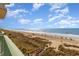 Beautiful view of the beach from a condo balcony and access walkway showing beachgoers at 2507 S Ocean Blvd. # 403, North Myrtle Beach, SC 29582