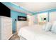Bright bedroom with a white dresser, modern fireplace, television and ensuite bathroom at 2507 S Ocean Blvd. # 403, North Myrtle Beach, SC 29582