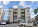 Low angle, full shot of the condominium building with parking in front and blue sky overhead at 2507 S Ocean Blvd. # 403, North Myrtle Beach, SC 29582