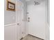 Hallway featuring beadboard, gray walls, and a large white metal front door at 2507 S Ocean Blvd. # 403, North Myrtle Beach, SC 29582