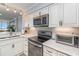 Bright kitchen with stainless steel appliances, white cabinets, and eat in counter at 2507 S Ocean Blvd. # 403, North Myrtle Beach, SC 29582