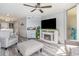 Well decorated living room featuring light gray wood floors, a ceiling fan and a fireplace at 2507 S Ocean Blvd. # 403, North Myrtle Beach, SC 29582