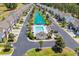 Aerial view of a community featuring a swimming pool, pond, mature trees and manicured lawns at 260 Connemara Dr. # E, Myrtle Beach, SC 29579