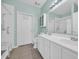 Well-lit bathroom features a double vanity, medicine cabinet, and accessible shower with a seat at 260 Connemara Dr. # E, Myrtle Beach, SC 29579