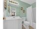 Bathroom featuring a white vanity, framed mirror and a shower-tub combo with a white shower curtain at 260 Connemara Dr. # E, Myrtle Beach, SC 29579