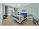 Bright bedroom with a ceiling fan, window with blinds, and a comfortable bed at 260 Connemara Dr. # E, Myrtle Beach, SC 29579