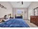Bedroom features a ceiling fan, dresser, and a door leading to the exterior at 260 Connemara Dr. # E, Myrtle Beach, SC 29579