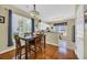Inviting dining area featuring a wooden table, hardwood floors, and a view of the kitchen at 260 Connemara Dr. # E, Myrtle Beach, SC 29579