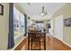 Cozy dining area with wood floors, ample natural light, and open view to the kitchen at 260 Connemara Dr. # E, Myrtle Beach, SC 29579