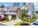 Inviting townhome with brick and siding facade, featuring a private garage and landscaped front yard at 260 Connemara Dr. # E, Myrtle Beach, SC 29579
