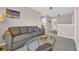 Bright living area with a comfortable sofa, glass coffee table, and view into other rooms at 260 Connemara Dr. # E, Myrtle Beach, SC 29579