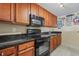 Well-equipped kitchen features wood cabinets, black appliances, and dark countertops for a stylish space at 2600 N Ocean Blvd. # 1103, Myrtle Beach, SC 29577