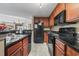 Modern kitchen features black appliances, granite countertops, and wood cabinets at 2600 N Ocean Blvd. # 1103, Myrtle Beach, SC 29577