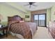 Comfortable bedroom with a ceiling fan, soft carpet and access to a private balcony with ocean views at 2600 N Ocean Blvd. # 1103, Myrtle Beach, SC 29577