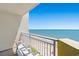 Relaxing balcony view overlooking the beach with clear blue skies and provided seating at 2701 S Ocean Blvd. # 1603, North Myrtle Beach, SC 29582