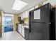 Efficient kitchen featuring black appliances, white cabinets, and access to the living area at 2701 S Ocean Blvd. # 1603, North Myrtle Beach, SC 29582