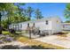 Exterior view of a well-maintained home featuring a fenced yard, hot tub, and golf cart at 2706 Willow St., North Myrtle Beach, SC 29582