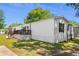 Picture of mobile home with a spacious wooden deck, American flag, and green lawn at 2706 Willow St., North Myrtle Beach, SC 29582