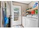Well-lit laundry room with modern washer and dryer, shelving, and exterior access at 2706 Willow St., North Myrtle Beach, SC 29582