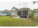 This backyard features a lawn, grill, screened in patio and privacy fencing at 2928 Moss Bridge Ln., Myrtle Beach, SC 29579