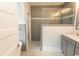 Bright bathroom features a shower with gray tiling and a white dual sink vanity at 2928 Moss Bridge Ln., Myrtle Beach, SC 29579