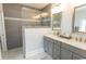 Bright bathroom features a shower with gray tiling and a white dual sink vanity at 2928 Moss Bridge Ln., Myrtle Beach, SC 29579