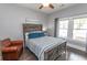 Comfortable bedroom with a ceiling fan, wood floors, and plenty of natural light at 2928 Moss Bridge Ln., Myrtle Beach, SC 29579