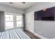 Cozy bedroom featuring white trim, soft curtains, a TV, and natural light at 2928 Moss Bridge Ln., Myrtle Beach, SC 29579