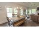 Bright dining room with large windows, wood table, and bench seating, adjacent to living spaces at 2928 Moss Bridge Ln., Myrtle Beach, SC 29579