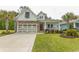 Charming single Gathering home featuring a stone and white siding, garage, and well-manicured lawn at 2928 Moss Bridge Ln., Myrtle Beach, SC 29579