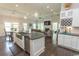 Open kitchen with stainless appliances, island sink, and seamless view of dining and living area at 2928 Moss Bridge Ln., Myrtle Beach, SC 29579