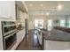 Modern kitchen with stainless steel appliances, granite countertops, and open view to the dining and living areas at 2928 Moss Bridge Ln., Myrtle Beach, SC 29579