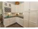 Bright kitchen featuring white cabinets, granite countertops, and a built-in wine rack at 2928 Moss Bridge Ln., Myrtle Beach, SC 29579